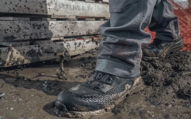 Waterproof Red Wing work boots in deep jobsite mud